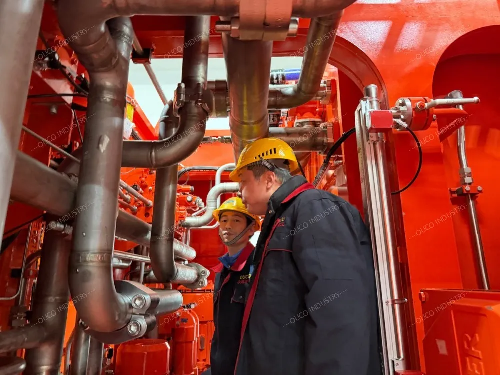 OUCO engineers inspecting hydraulic piping and valve systems